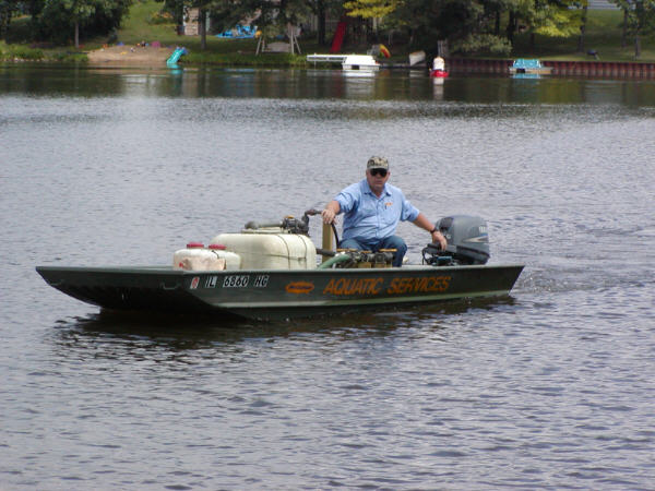 Lyle Erickson in the McCloud Services boat on Lake Waterford